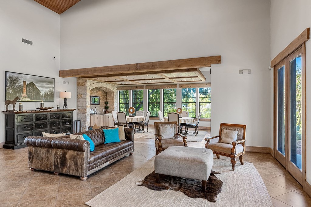 a living room with couches and chairs and a rug