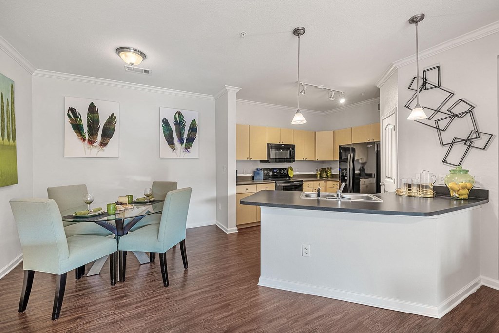an open kitchen and dining area with a table and chairs
