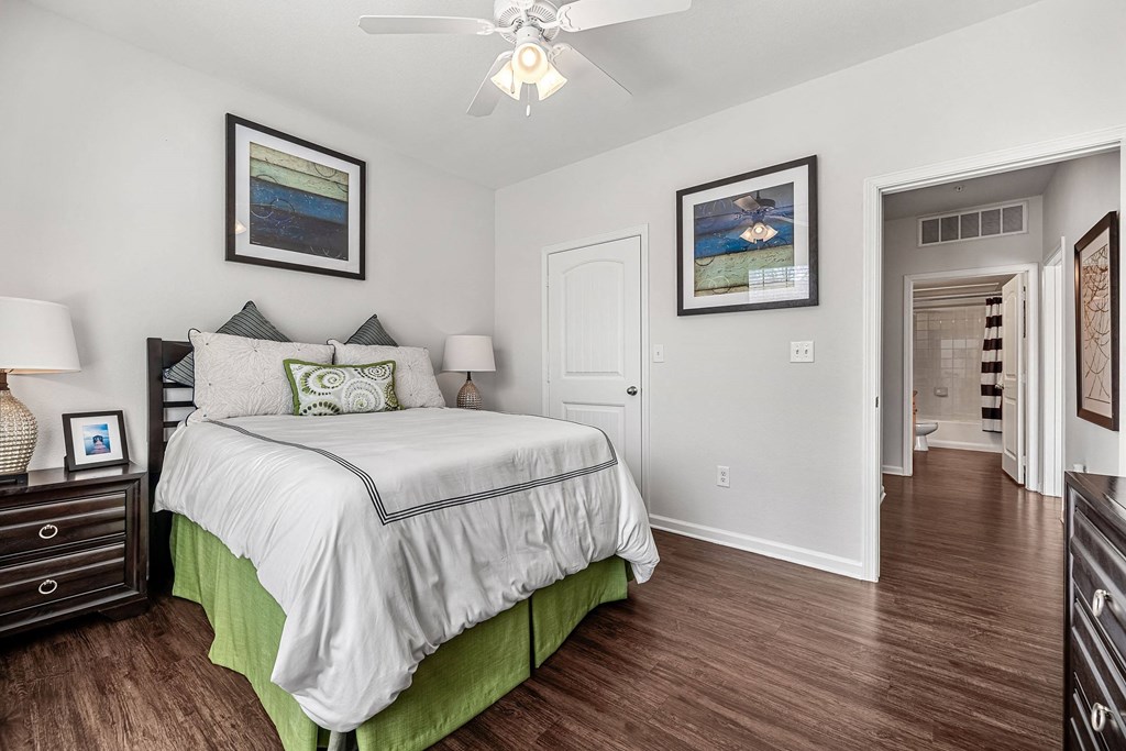 a bedroom with a bed and a ceiling fan