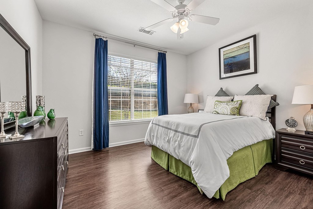 a bedroom with a bed and a ceiling fan