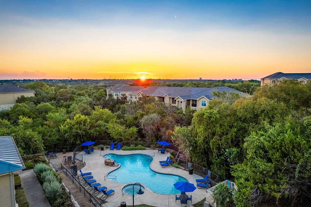 a aerial view of a swimming pool at sunset