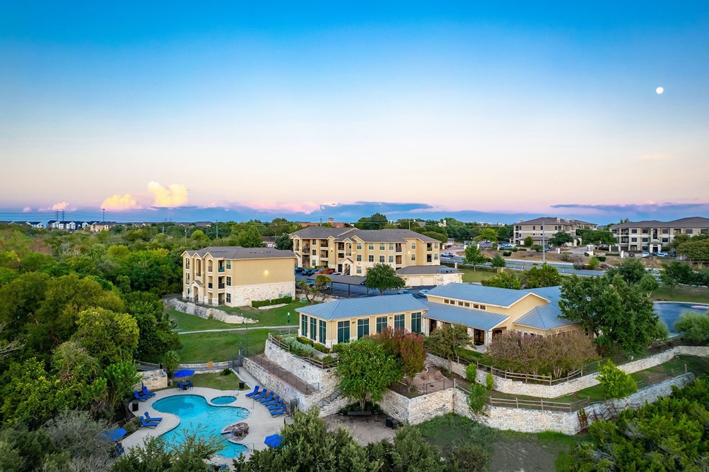 an aerial view of the resort with the ocean in the background
