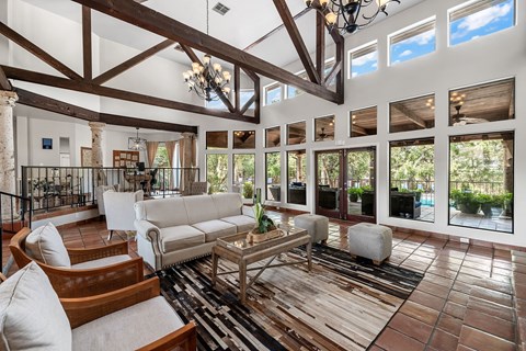 a living room with couches and chairs and a table