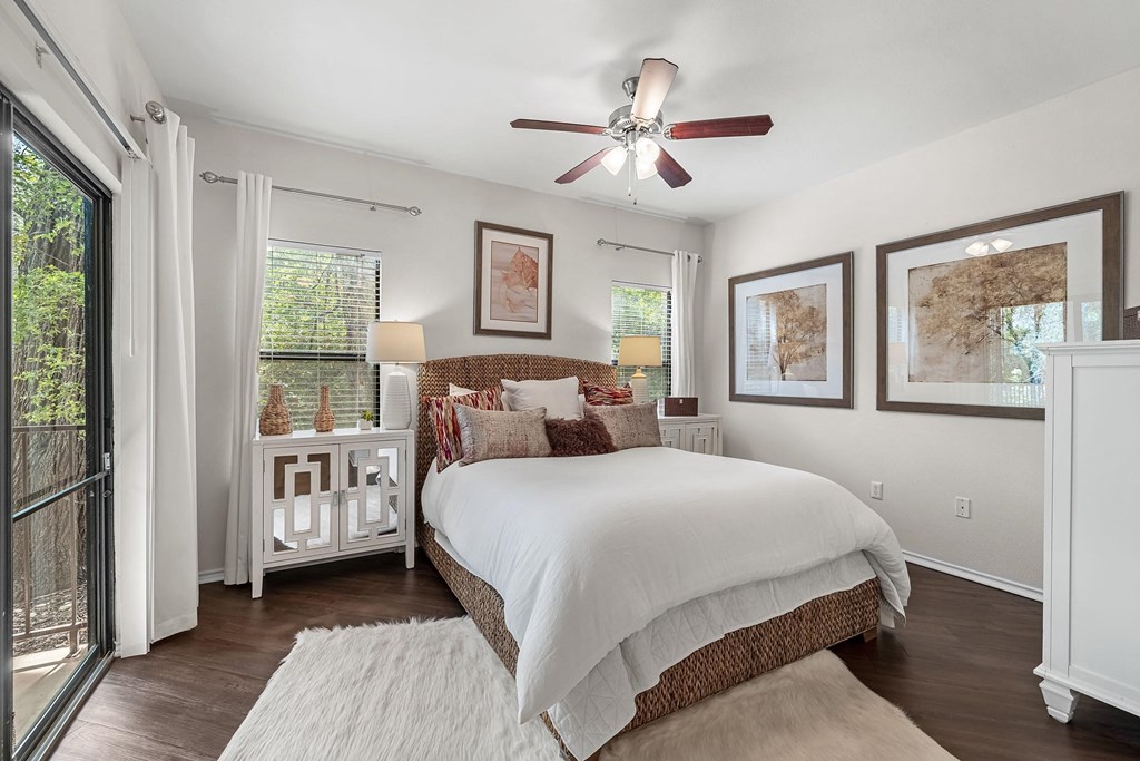 a bedroom with a bed and a ceiling fan