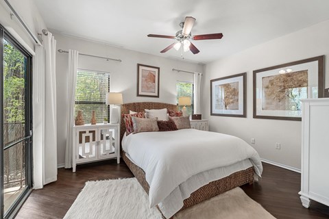 a bedroom with a bed and a ceiling fan