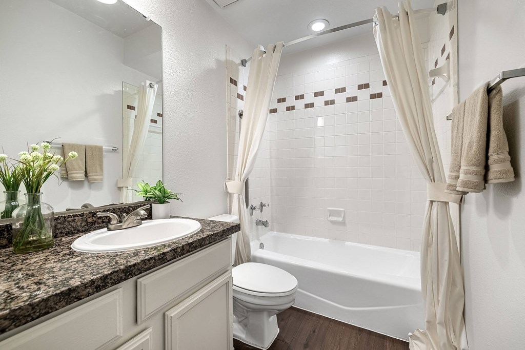 a white bathroom with a sink and a toilet