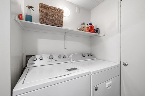 a white washer and dryer in a room with ultraviolet lights