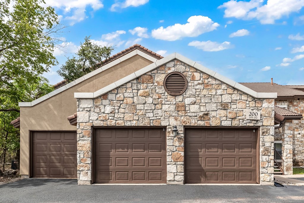 a house with two garage doors on the side of it