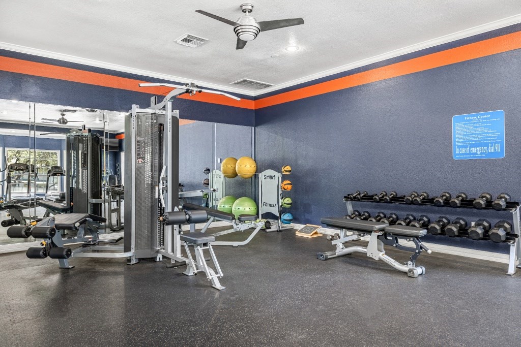 a fitness room with weights and other exercise equipment