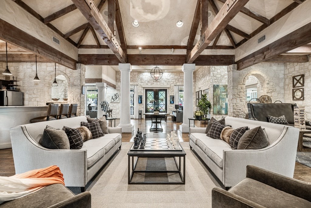 a living room filled with furniture and a large window