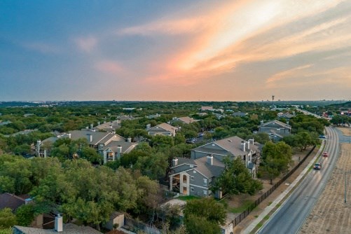 an aerial view of a neighborhood with rows of houses and trees