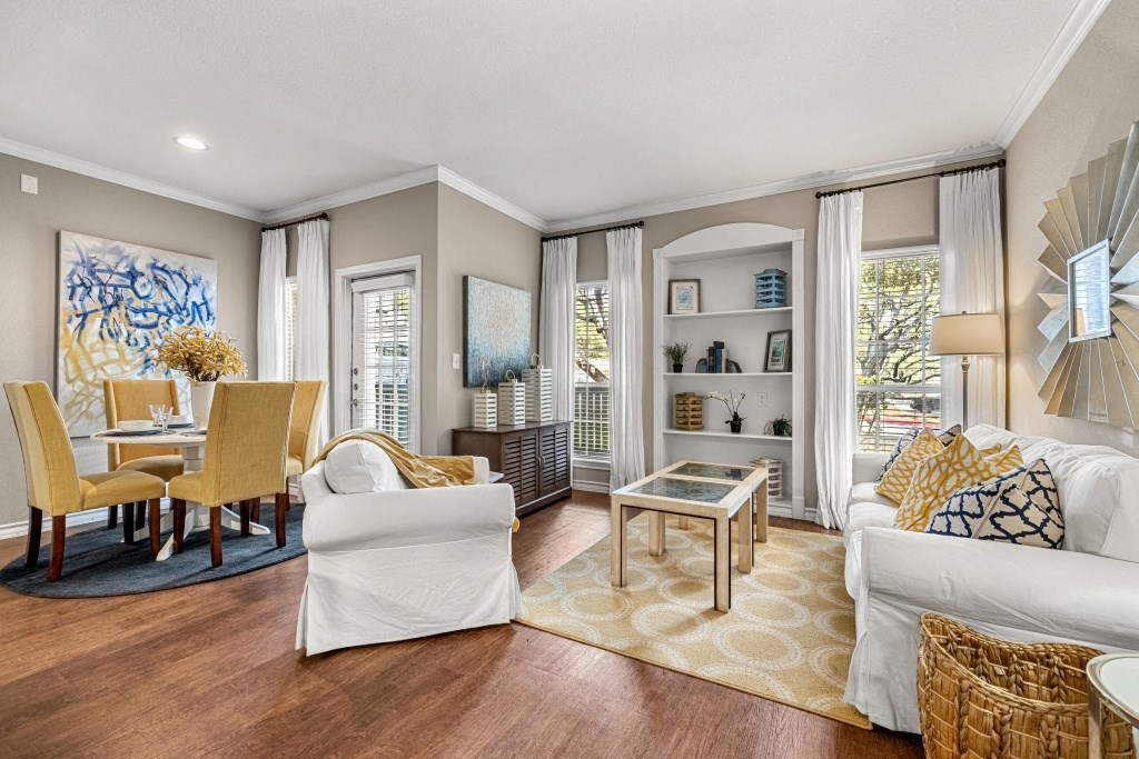 a living room and dining room with a table and chairs