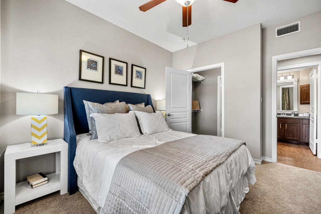 a bedroom with a bed and a ceiling fan