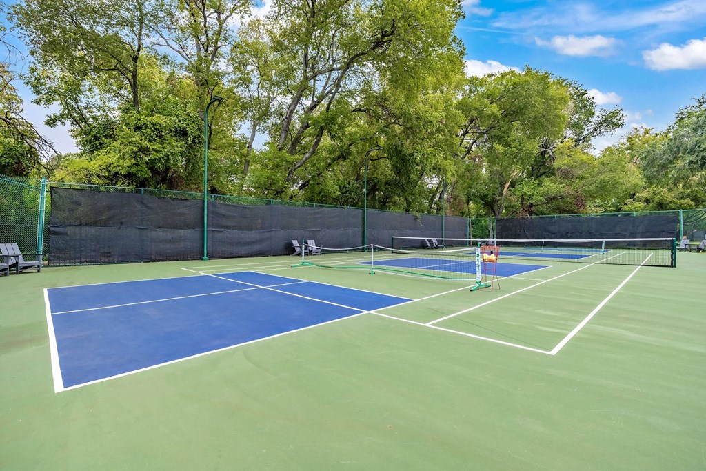 two tennis courts on a blue and green tennis court