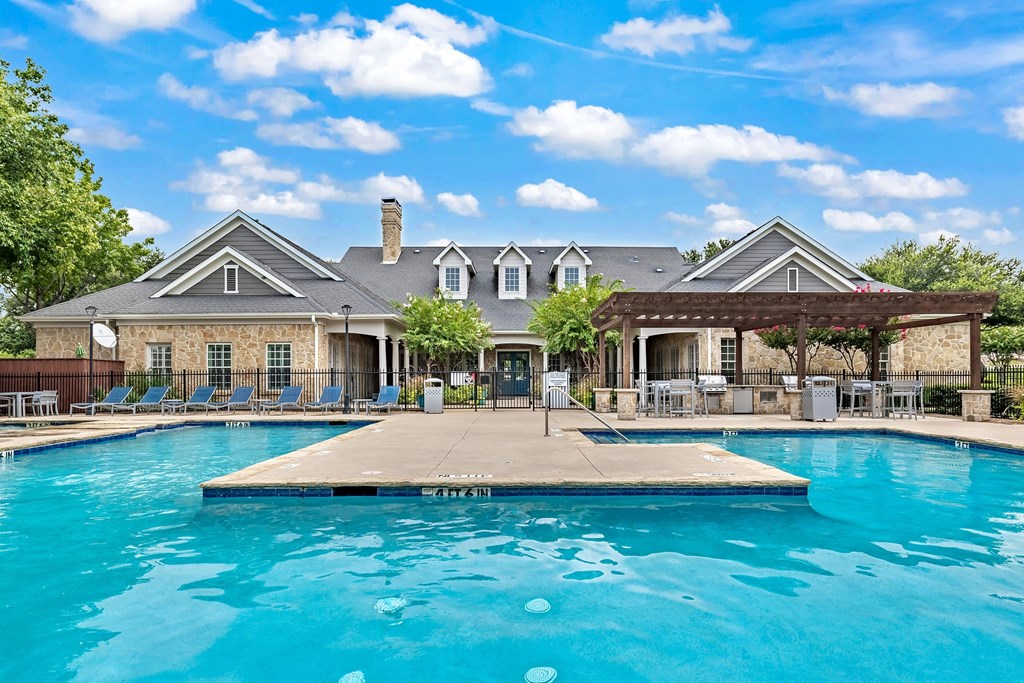 a swimming pool with a house in the background
