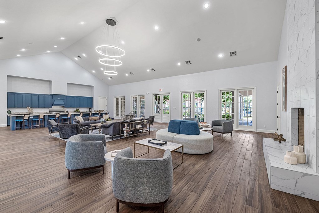 a lobby with couches chairs and tables and a fireplace