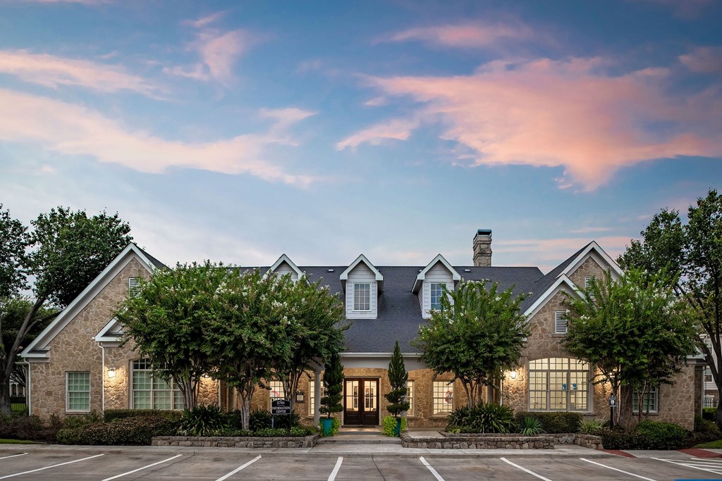 exterior of a house with trees in a parking lot
