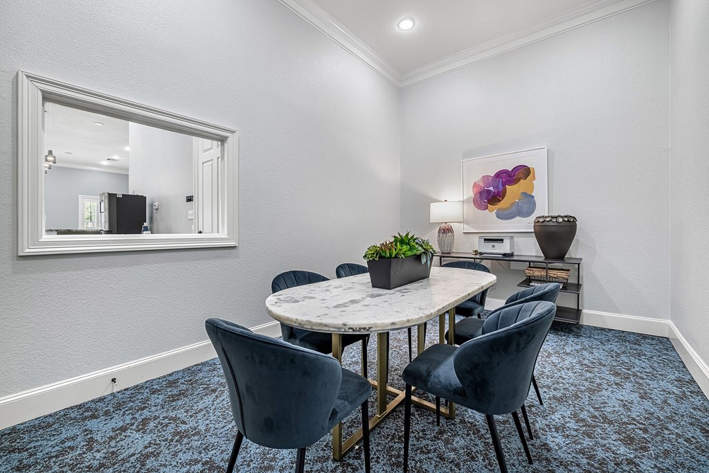 a dining room with a marble table and chairs