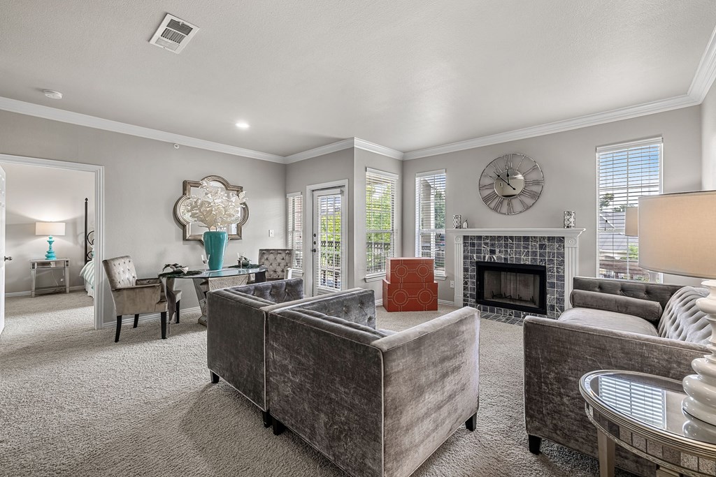 a living room with couches and chairs and a fireplace