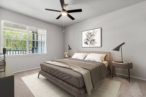 A bedroom with a bed, a ceiling fan, and a window with blinds.