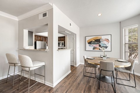 A dining room with a table and chairs.