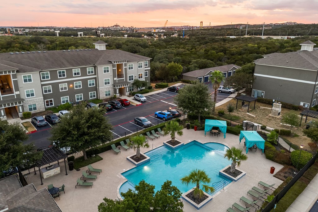 an aerial view of the resort style pool at dusk