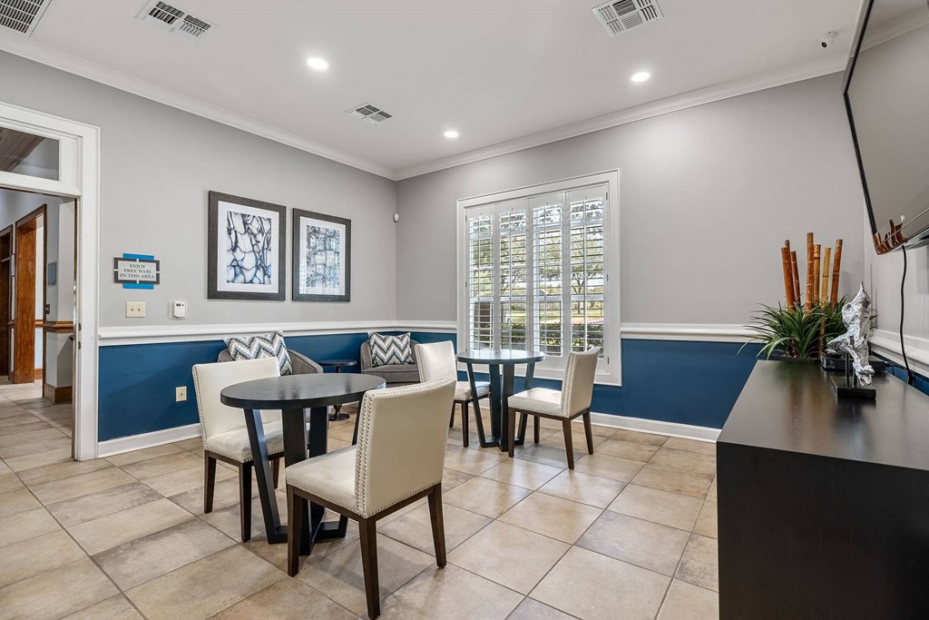 a dining area with a table and chairs