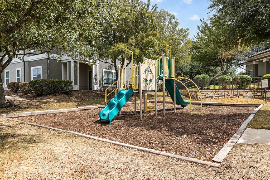 a playground at the whispering winds apartments in pearland, tx