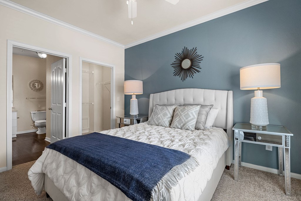 a bedroom with a bed and two night stands