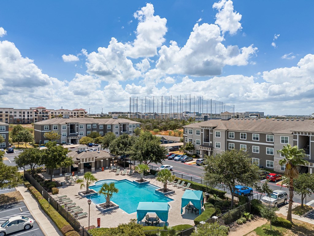 an aerial view of the resort style pool at the enclave at woodbridge apartments in sugar land