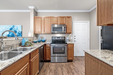 A kitchen with wooden cabinets and stainless steel appliances.