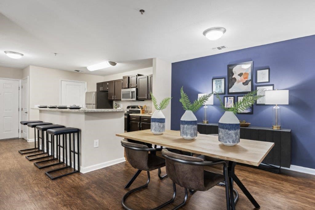 a dining room and kitchen with a table and chairs