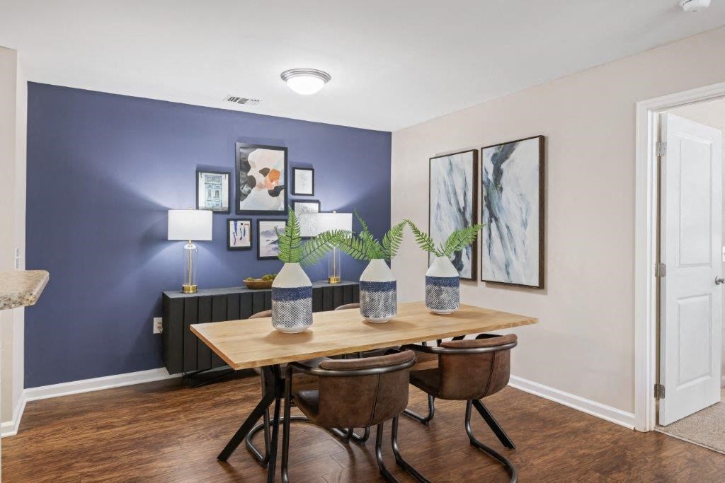 a dining room with a table and chairs