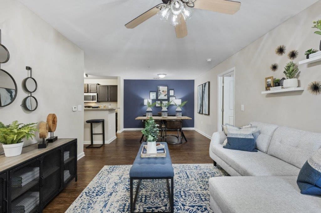 a living room with furniture and a ceiling fan