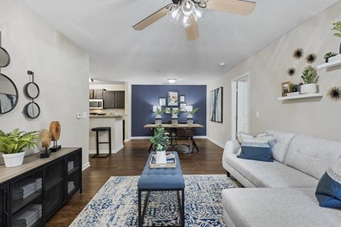 A living room with a white couch and a blue coffee table.