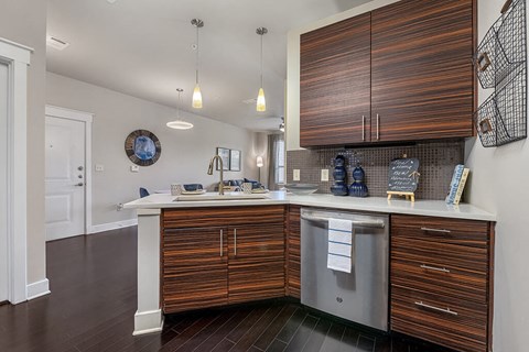 A kitchen with wooden cabinets and a white counter.