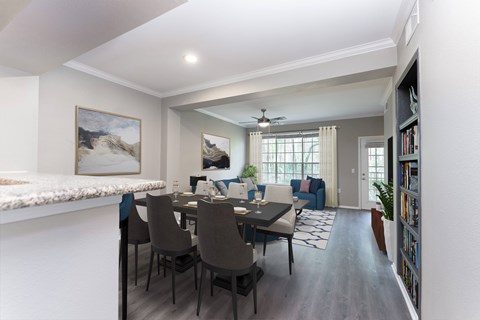 A dining room with a table set for six.