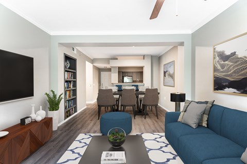 A living room with a blue couch and a coffee table.