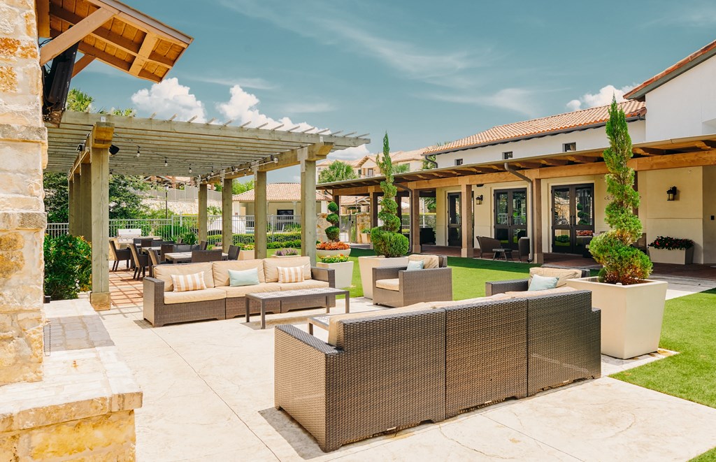 A patio with a couch and a table with chairs.