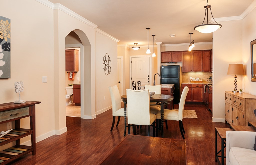 A dining room with a table and chairs.