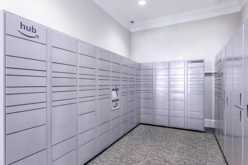 a row of metal lockers in a white room with a carpet