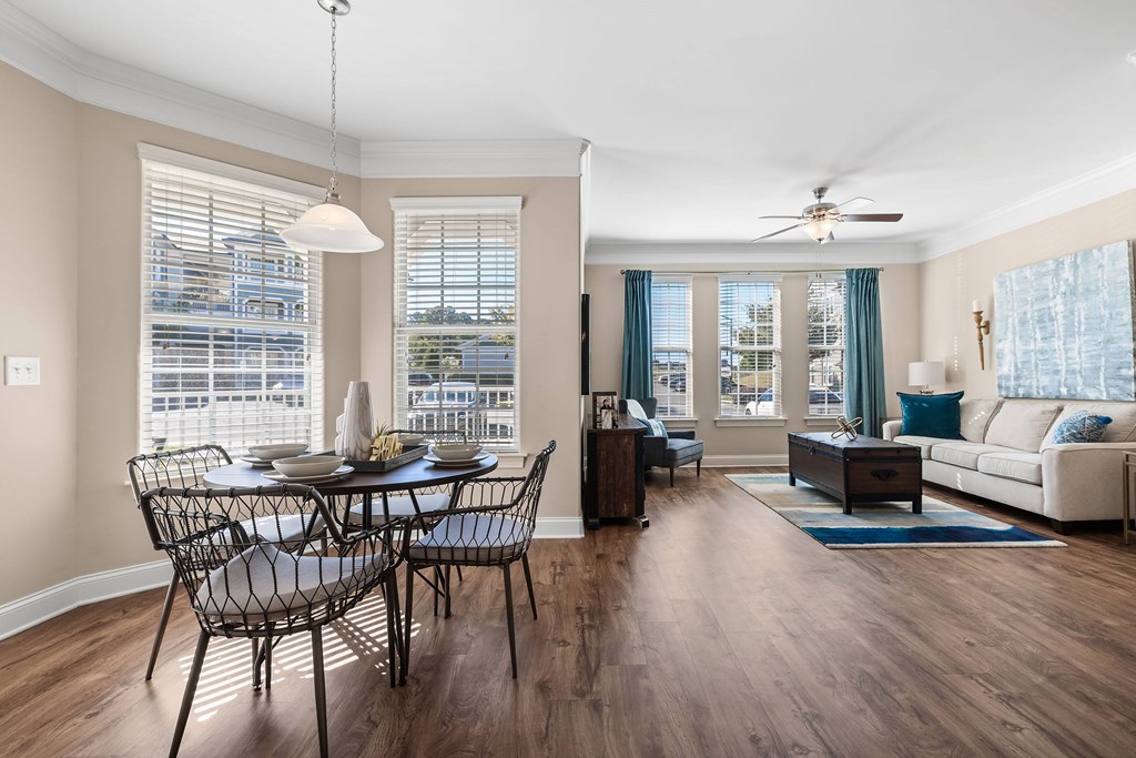 A modern dining room with a glass table and chairs.