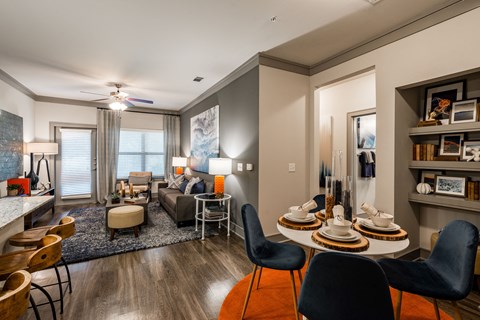 a living room with a table and chairs in front of a couch