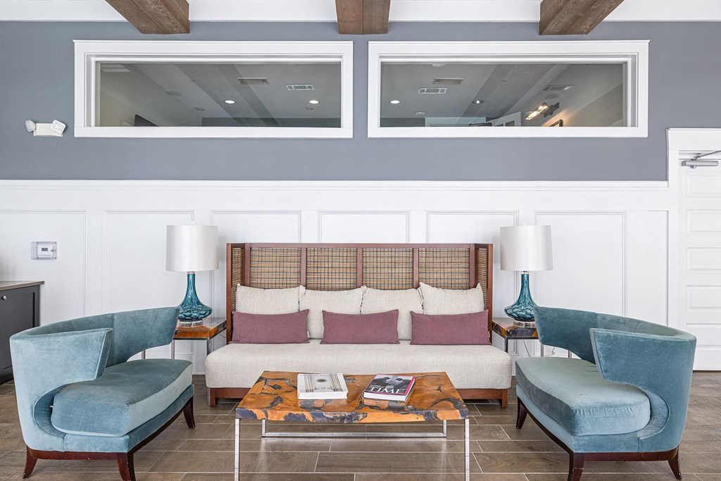 a living room with a couch and two blue chairs