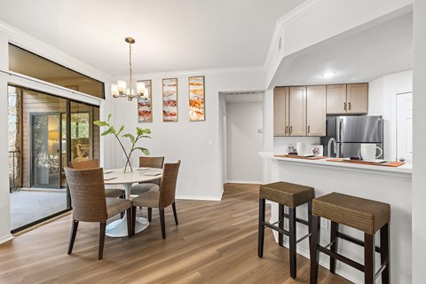 A dining room with a table and chairs.