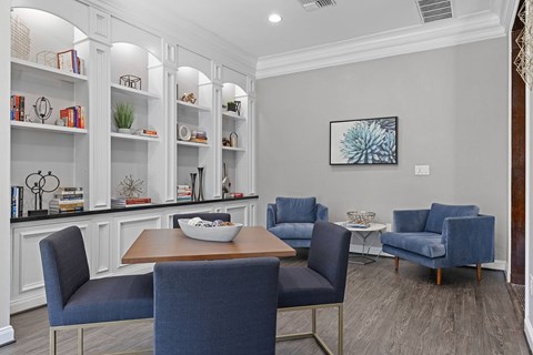 A dining room with a wooden table and blue chairs.