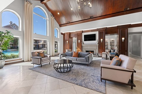 A large, well-furnished living room with a fireplace and a television.
