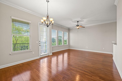 Spacious living and dining room with wood styled flooring and natural light