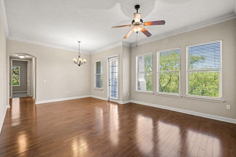 Spacious living and dining room with wood styled flooring and natural light