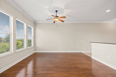 Spacious living and dining room with wood styled flooring and natural light